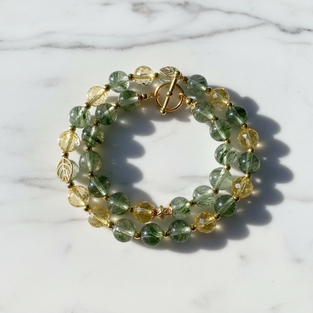 Green Phantom Crystal Wealth Bracelet with Citrine and Gold Charm on white marble